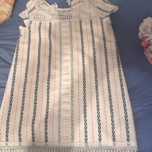 A dress that’s pink, cream, and blue